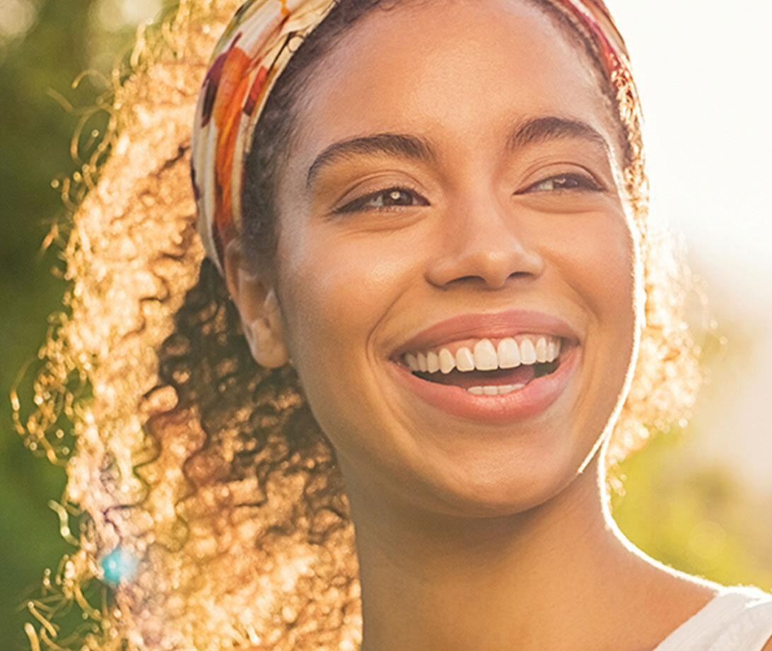 A woman smiling outdoors